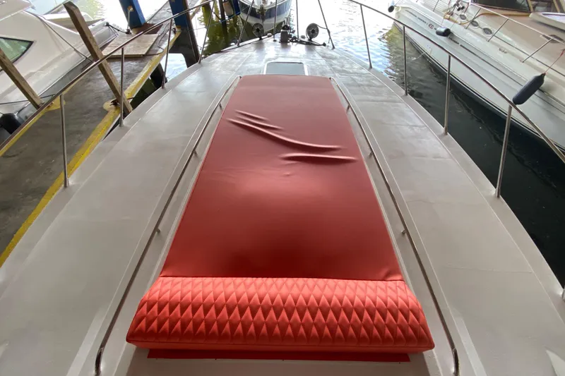 Slide: The Image of 1993 Wellcraft 4300 Portofino boat deck with red cushioned seating. - 12