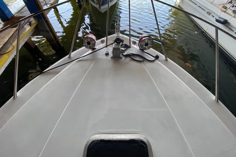 Slide: The Image of 1993 Wellcraft 4300 Portofino boat deck with railing and docked surroundings. - 13