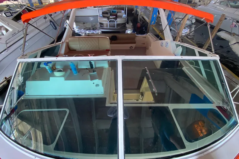 Slide: The Image of 1993 Wellcraft 4300 Portofino boat interior with orange canopy and seating area. - 16