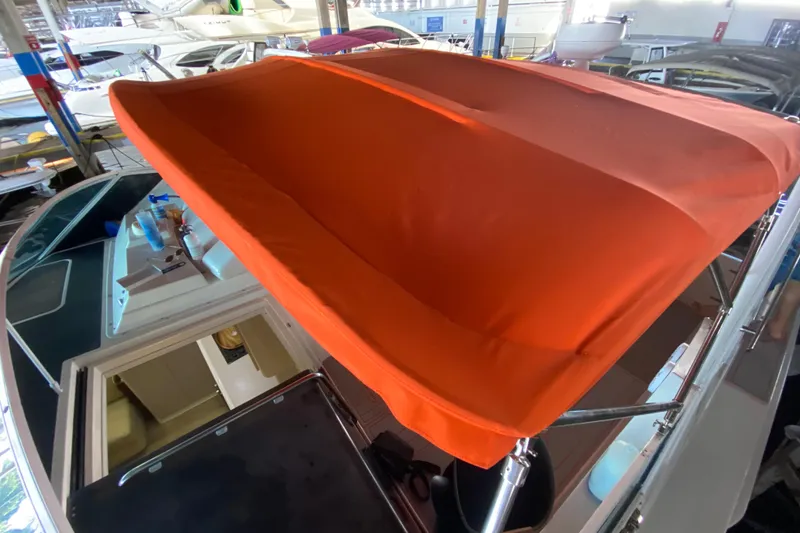 Slide: The Image of 1993 Wellcraft 4300 Portofino with orange canopy in a marina setting. - 18