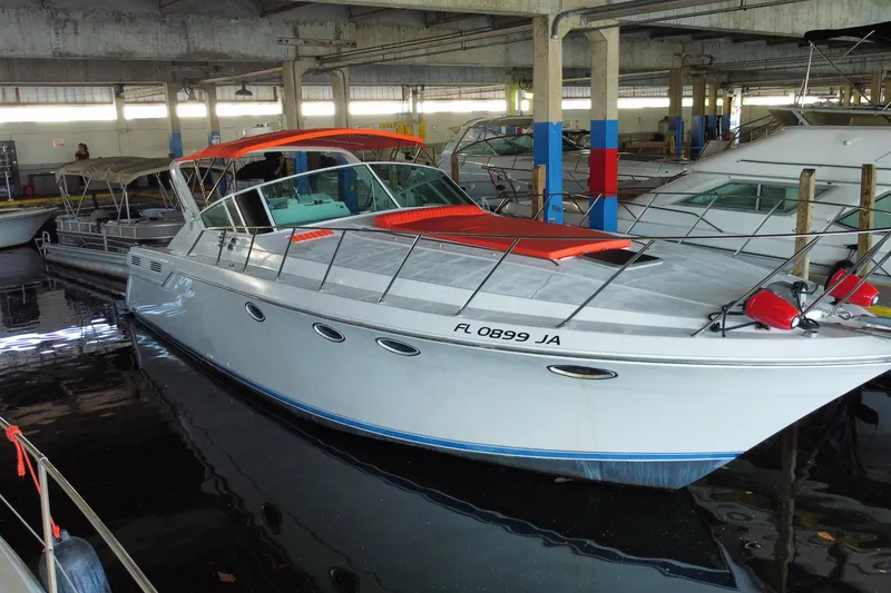 Slide: The Image of 1993 Wellcraft 4300 Portofino yacht docked in a marina, featuring sleek design and vibrant accents. - 2