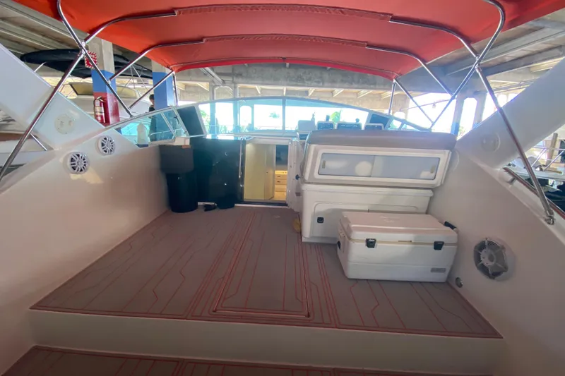 Slide: The Image of 1993 Wellcraft 4300 Portofino boat interior with red canopy and seating area. - 21