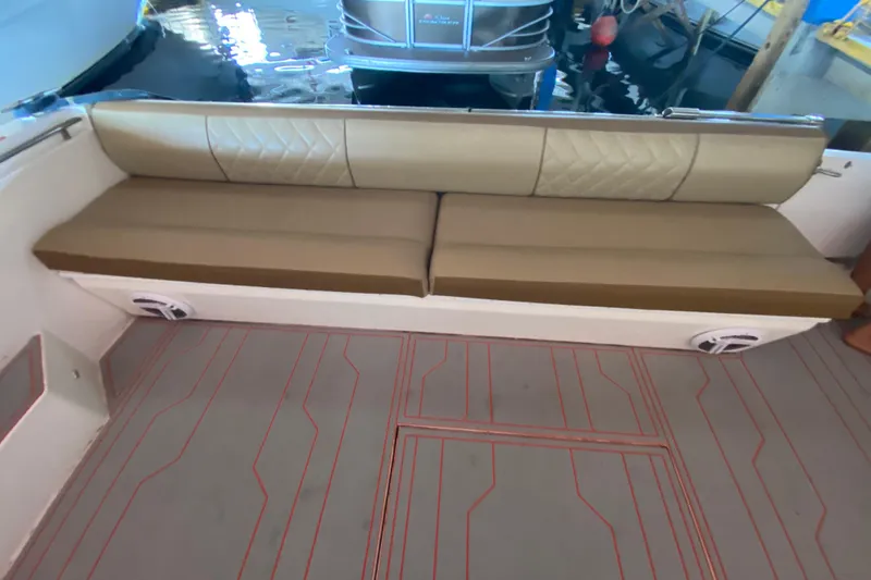 Slide: The Image of 1993 Wellcraft 4300 Portofino boat interior with cushioned seating and patterned flooring. - 24