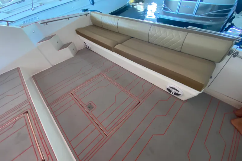 Slide: The Image of 1993 Wellcraft 4300 Portofino boat interior with beige seating and patterned flooring. - 25