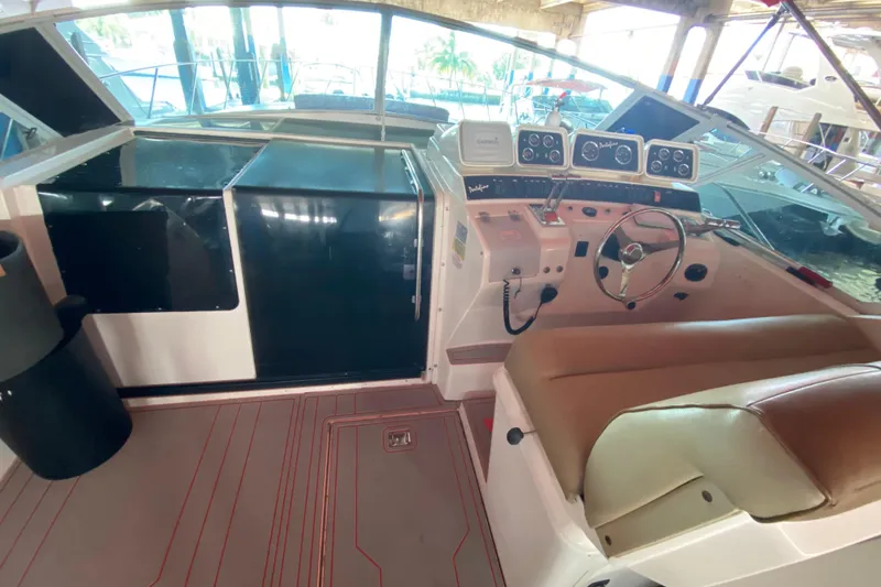 Slide: The Image of 1993 Wellcraft 4300 Portofino boat cockpit with steering wheel and control panel. - 29