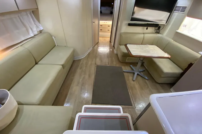 Slide: The Image of Interior of 1993 Wellcraft 4300 Portofino yacht with beige seating and wooden flooring. - 33