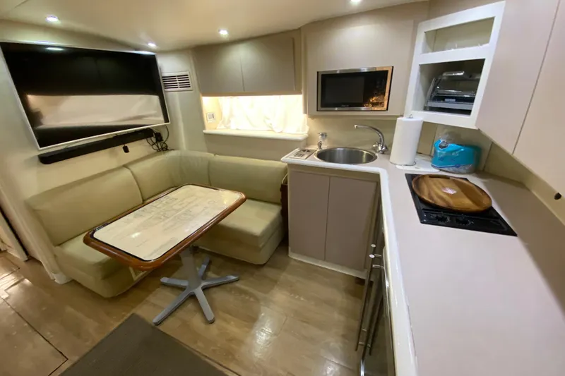 Slide: The Image of Interior of 1993 Wellcraft 4300 Portofino yacht with kitchen and seating area. - 34