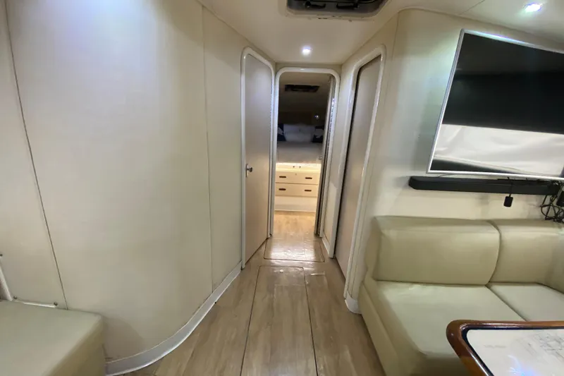 Slide: The Image of Interior of 1993 Wellcraft 4300 Portofino yacht, featuring modern seating and a flat-screen TV. - 36