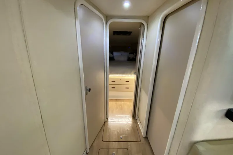 Slide: The Image of Interior hallway of 1993 Wellcraft 4300 Portofino yacht, featuring wooden flooring and cabin access. - 38