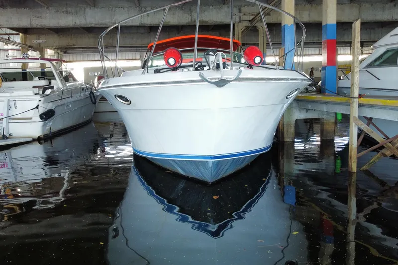 Slide: The Image of 1993 Wellcraft 4300 Portofino yacht docked in a marina, front view. - 4