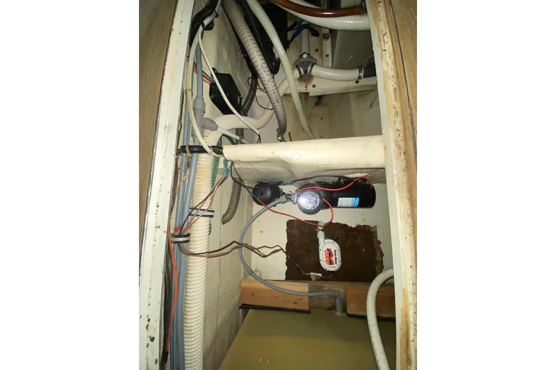 Slide: The Image of 1993 Wellcraft 4300 Portofino engine compartment with wiring and hoses visible. - 47