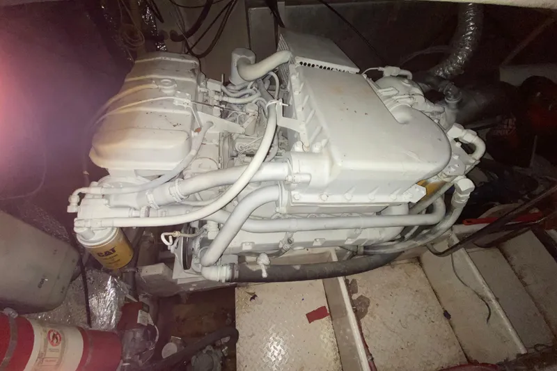 Slide: The Image of Engine compartment of a 1993 Wellcraft 4300 Portofino yacht, featuring a white engine. - 51