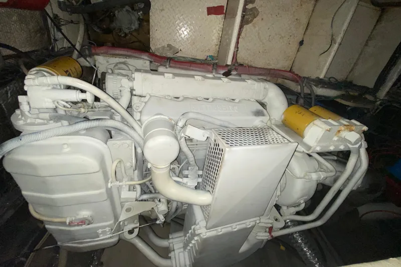 Slide: The Image of Engine compartment of a 1993 Wellcraft 4300 Portofino boat, showcasing mechanical components. - 52