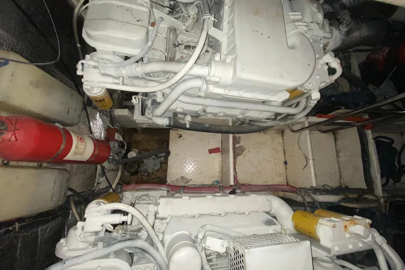 Slide: The Image of Engine room of 1993 Wellcraft 4300 Portofino with visible machinery and fire extinguisher. - 53