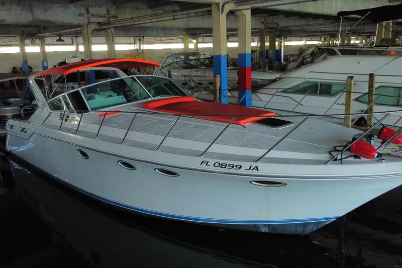 Slide: The Image of 1993 Wellcraft 4300 Portofino yacht docked in a marina, featuring a sleek design. - 7