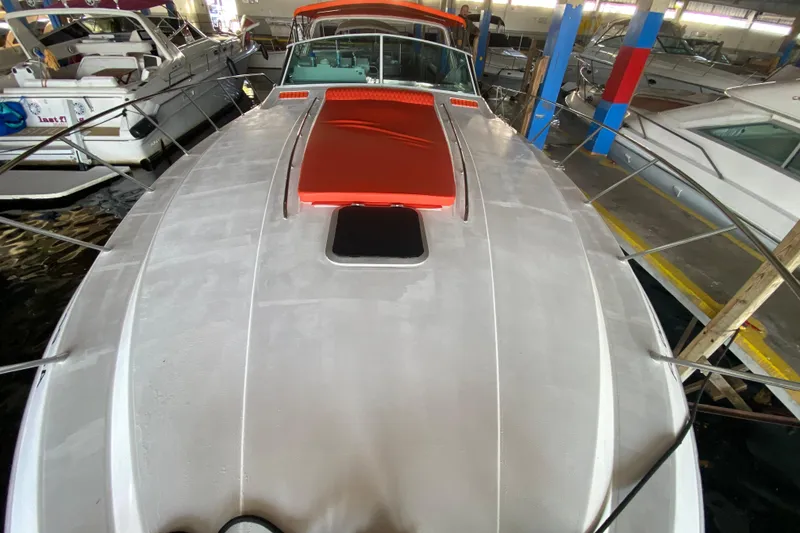 Slide: The Image of 1993 Wellcraft 4300 Portofino yacht docked in a marina, showcasing sleek design and vibrant accents. - 9