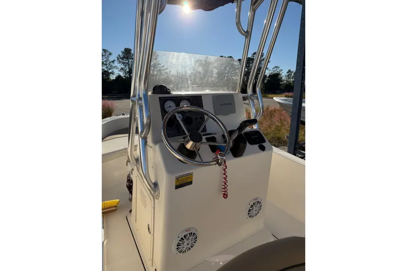 Slide: The Image of 2016 Pioneer 175 Bay Sport boat console with steering wheel and gauges in sunlight. - 10