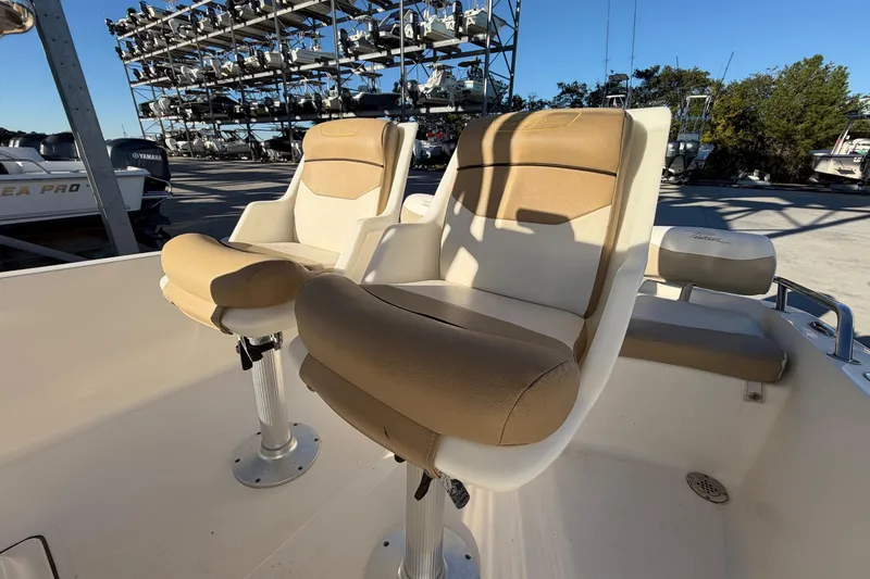 Slide: The Image of 2016 Pioneer 175 Bay Sport boat interior with tan and white seating. - 17