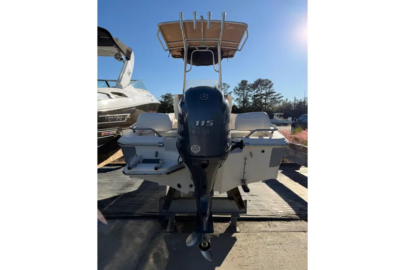Slide: The Image of 2016 Pioneer 175 Bay Sport boat with Yamaha 115 outboard motor, docked under clear sky. - 3