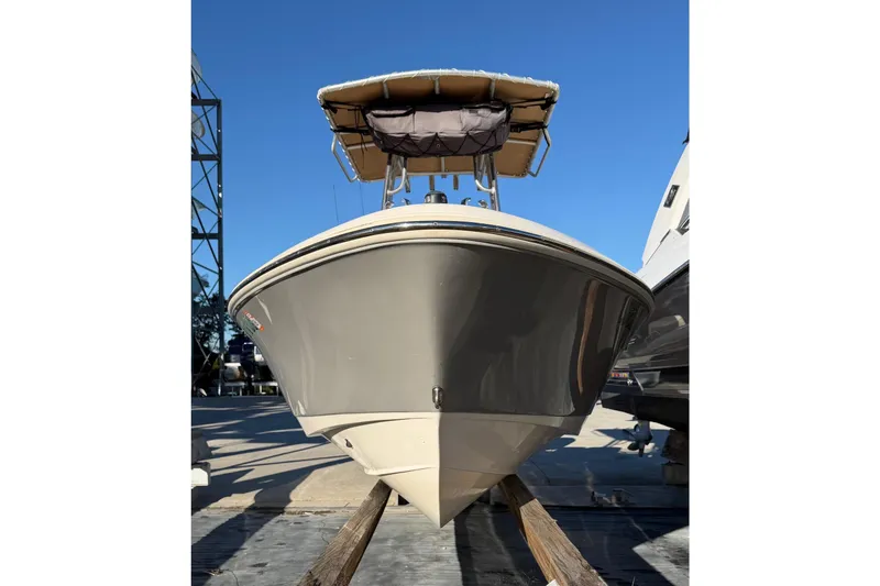 Slide: The Image of 2016 Pioneer 175 Bay Sport boat with canopy, displayed outdoors under clear blue sky. - 4