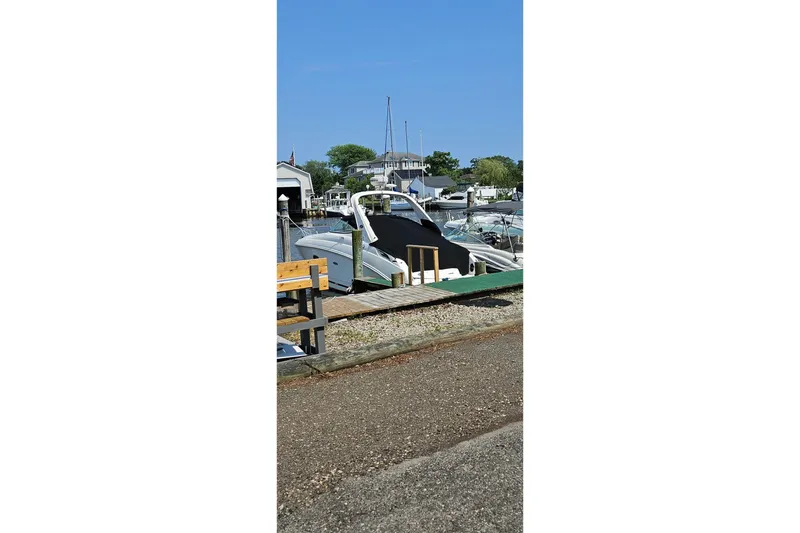 Slide: The Image of 2009 Sea Ray 270 Sundancer docked at a marina under clear blue skies. - 2