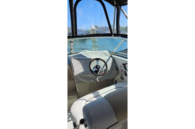 Slide: The Image of Interior view of 2009 Sea Ray 270 Sundancer boat cockpit with steering wheel. - 5
