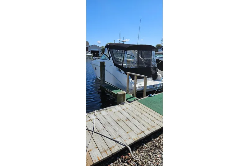 Slide: The Image of 2009 Sea Ray 270 Sundancer docked at marina under clear blue sky. - 6