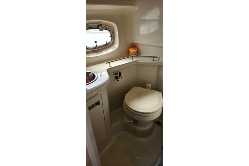 Slide: The Image of 2009 Sea Ray 270 Sundancer boat bathroom with toilet and sink. - 7