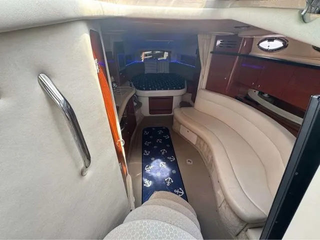 Slide: The Image of Interior of 2004 Sea Ray 320 Sundancer yacht with seating and sleeping area. - 4