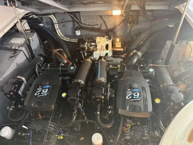 Slide: The Image of Engine compartment of a 2004 Sea Ray 320 Sundancer boat, showcasing dual engines. - 6