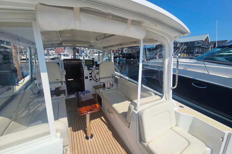 Slide: The Image of 2023 MJM 35 boat interior with seating, helm, and marina view. - 18