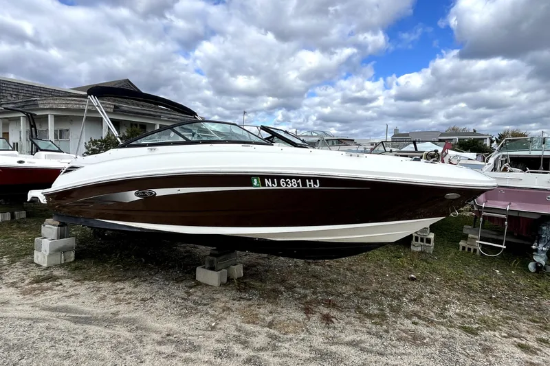 The Image of 2016 Sea Ray 220 Sundeck boat on blocks, cloudy sky background. - 0