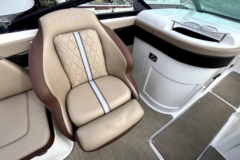 Slide: The Image of Luxurious seating on 2016 Sea Ray 220 Sundeck boat, featuring beige and brown upholstery. - 15