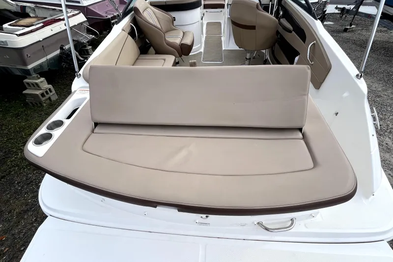 Slide: The Image of 2016 Sea Ray 220 Sundeck boat interior with beige seating and cup holders. - 19