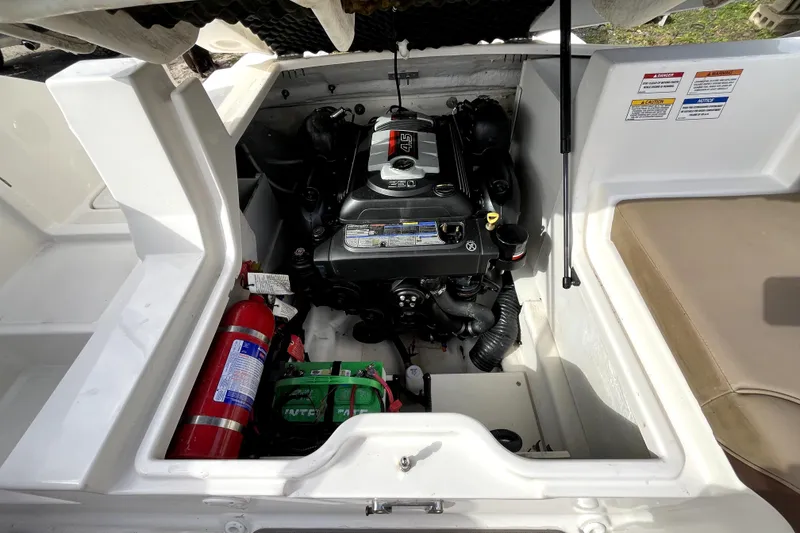 Slide: The Image of Engine compartment of a 2016 Sea Ray 220 Sundeck with visible fire extinguisher and battery. - 22