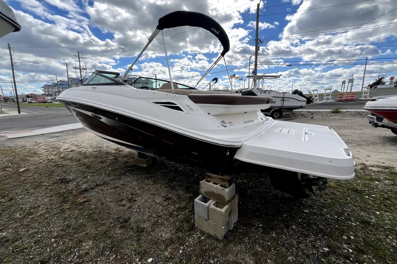 Slide: The Image of 2016 Sea Ray 220 Sundeck boat on display under a cloudy sky. - 3