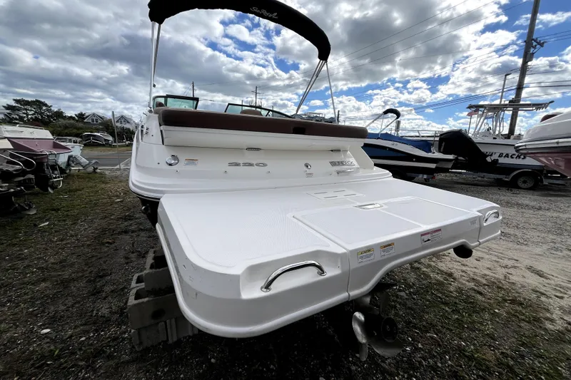 Slide: The Image of 2016 Sea Ray 220 Sundeck boat on display under cloudy sky. - 4