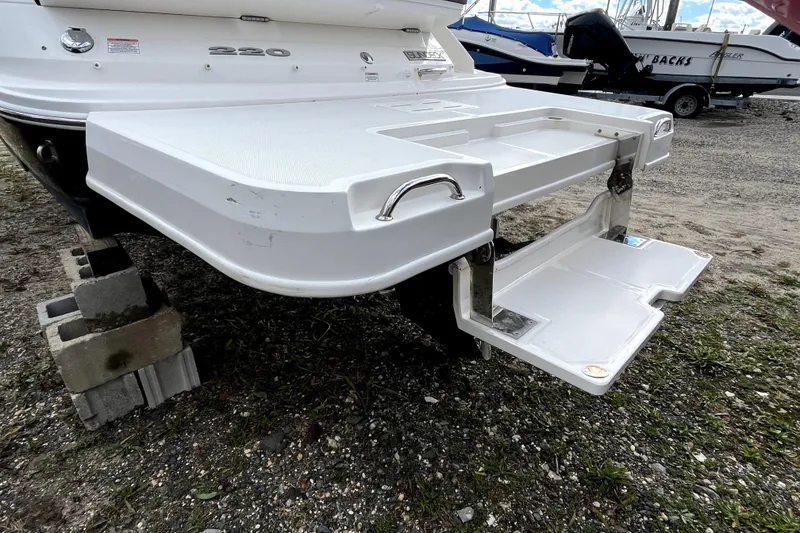 Slide: The Image of 2016 Sea Ray 220 Sundeck boat with extended swim platform on display. - 5