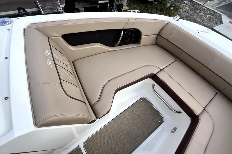 Slide: The Image of 2016 Sea Ray 220 Sundeck interior with beige seating and elegant design. - 8