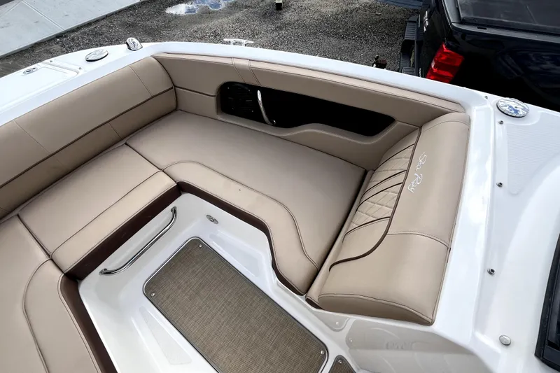 Slide: The Image of 2016 Sea Ray 220 Sundeck interior with beige seating and elegant design. - 9