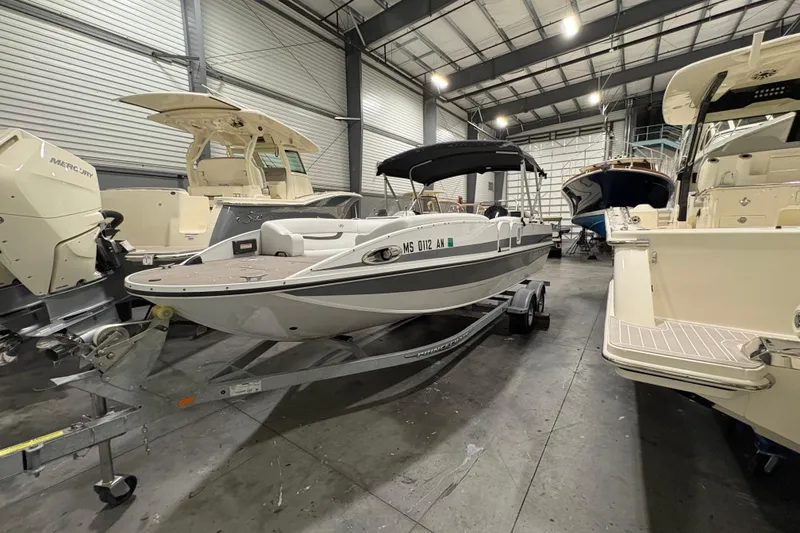 Slide: The Image of 2022 Princecraft Ventura 224 boat in a showroom, surrounded by other boats. - 10