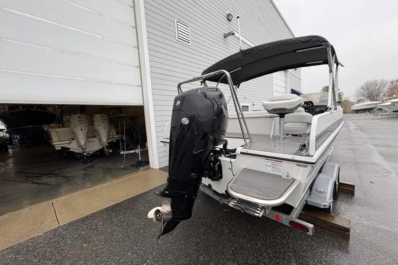 Slide: The Image of 2022 Princecraft Ventura 224 boat with outboard motor, parked outside a storage facility. - 3