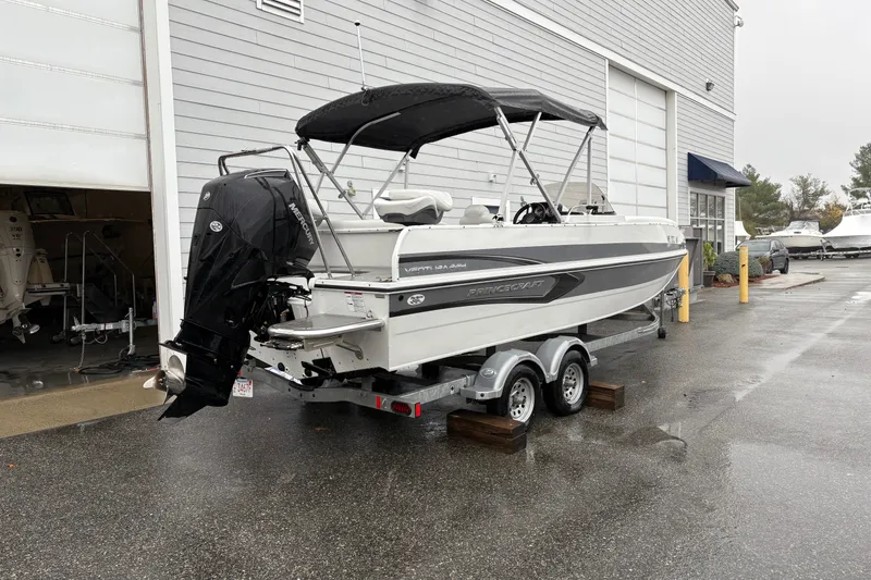Slide: The Image of 2022 Princecraft Ventura 224 boat on trailer, parked outside a building on a rainy day. - 4