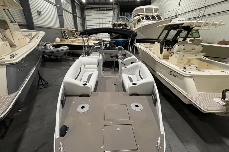 Slide: The Image of 2022 Princecraft Ventura 224 boat in showroom, surrounded by other boats. - 9
