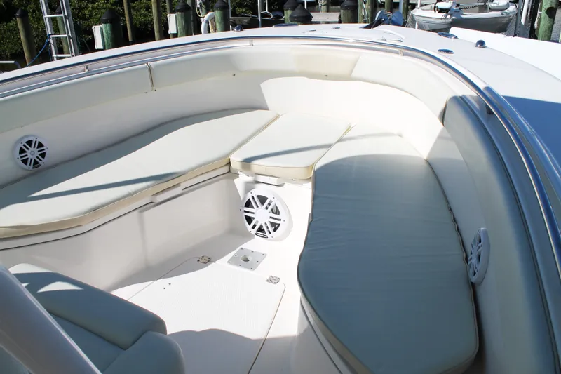Slide: The Image of 2016 Robalo R300 Center Console boat interior with cushioned seating and speakers. - 10