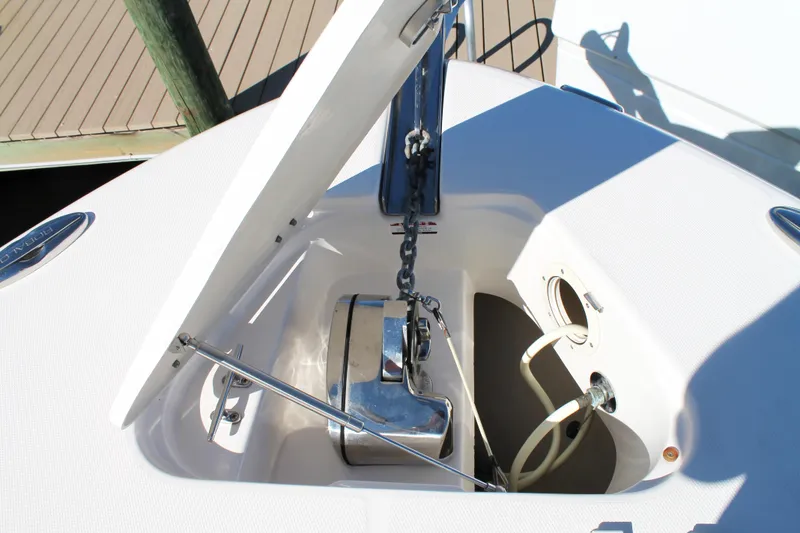 Slide: The Image of 2016 Robalo R300 Center Console anchor compartment with open hatch and chain mechanism. - 14