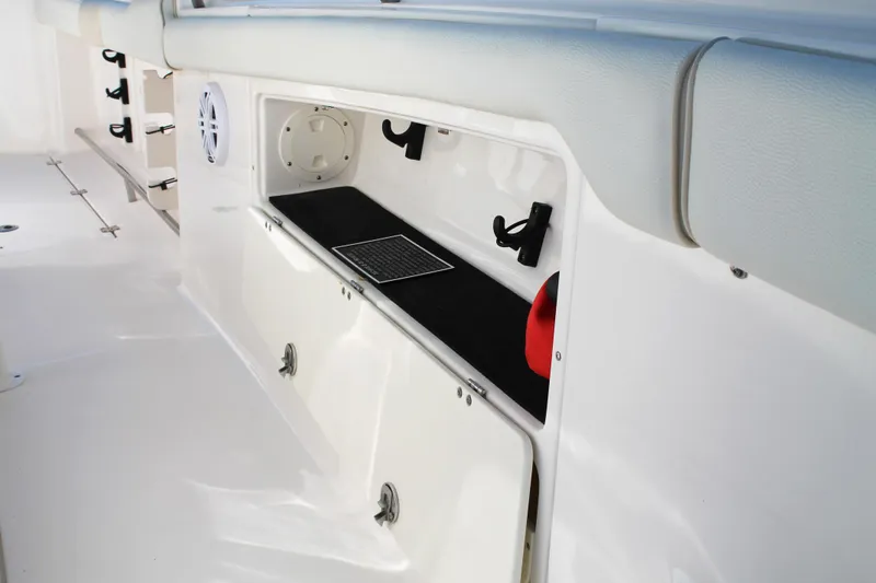 Slide: The Image of 2016 Robalo R300 Center Console boat storage compartment with cushioned seating. - 15