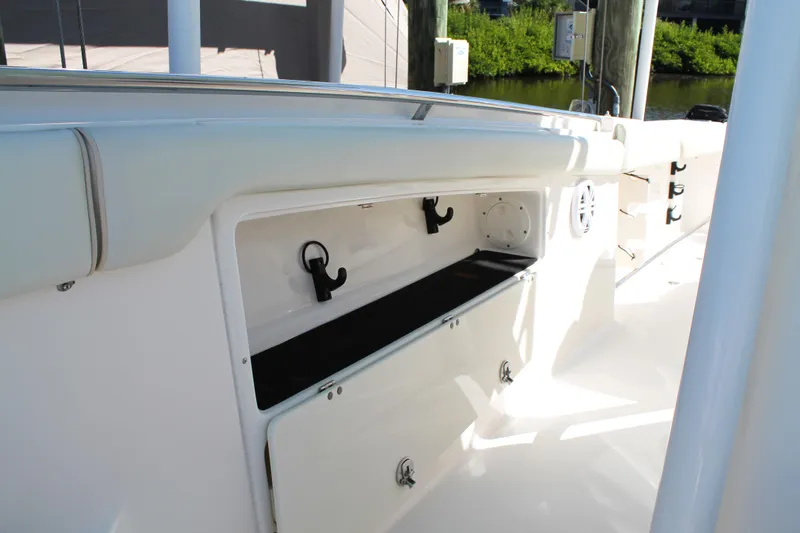 Slide: The Image of 2016 Robalo R300 Center Console boat storage compartment, open and empty. - 16