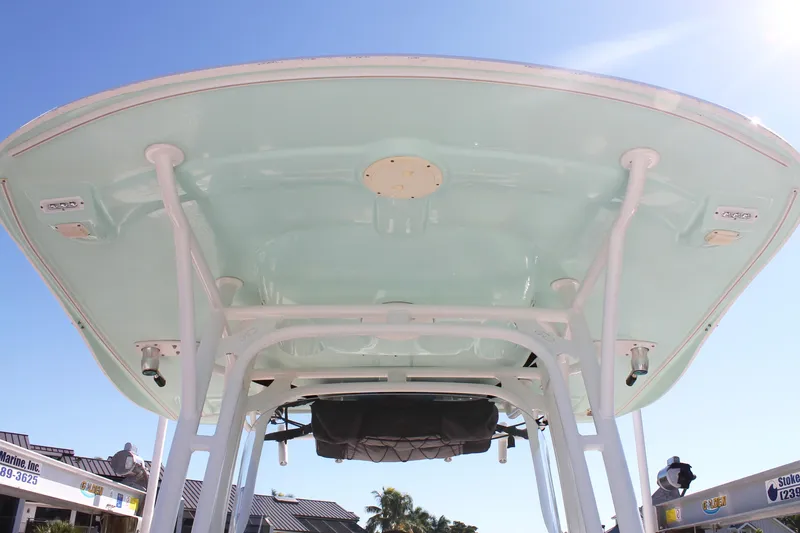 Slide: The Image of 2016 Robalo R300 Center Console boat's T-top against clear blue sky. - 18