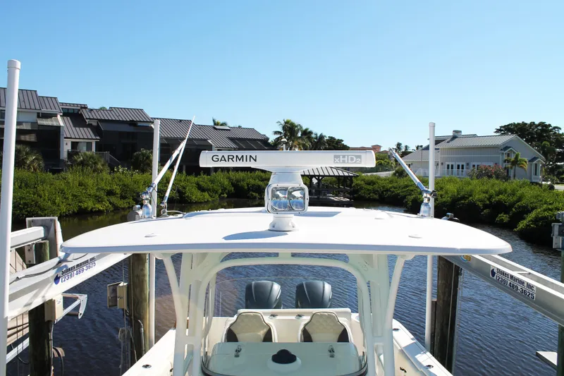 Slide: The Image of 2016 Robalo R300 Center Console boat docked with Garmin radar, scenic waterfront view. - 19